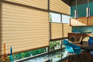 Sun shining through Teardrop Roman shades, adjusted to different heights